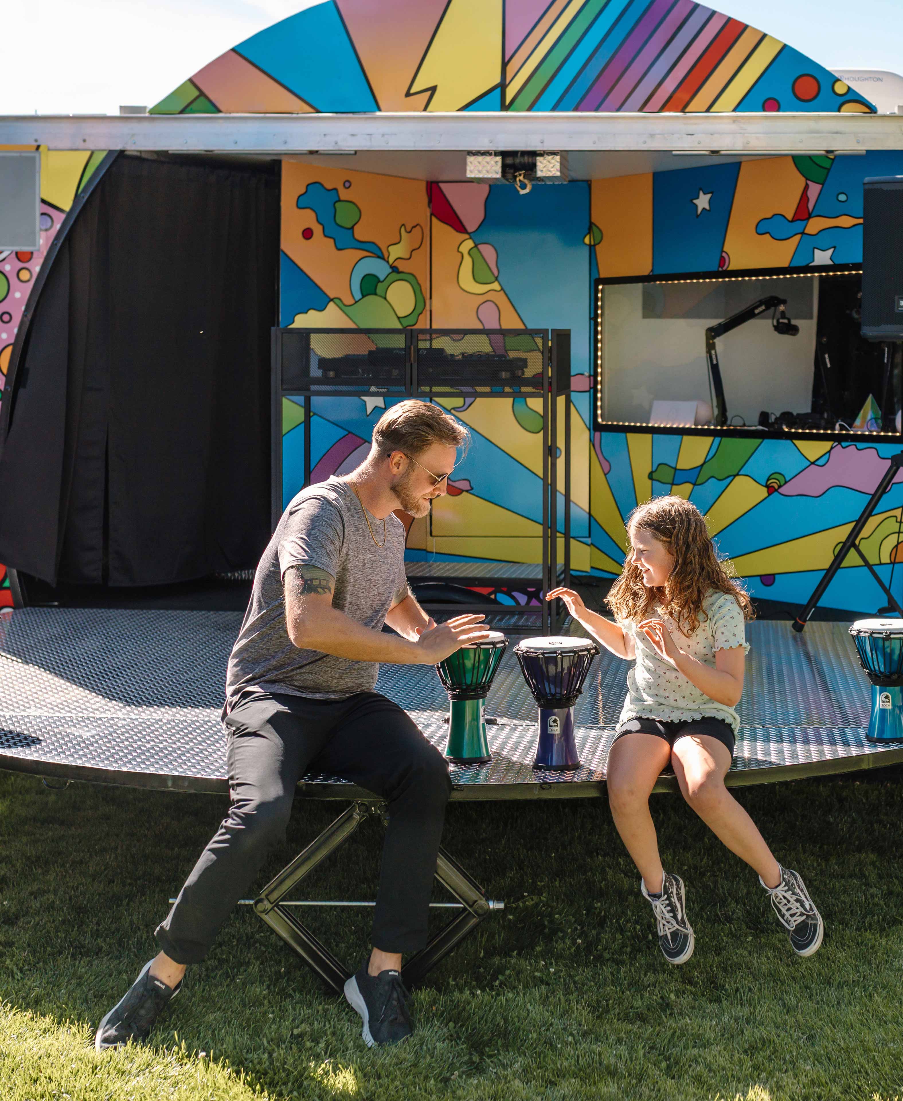 father and daughter playing with drums