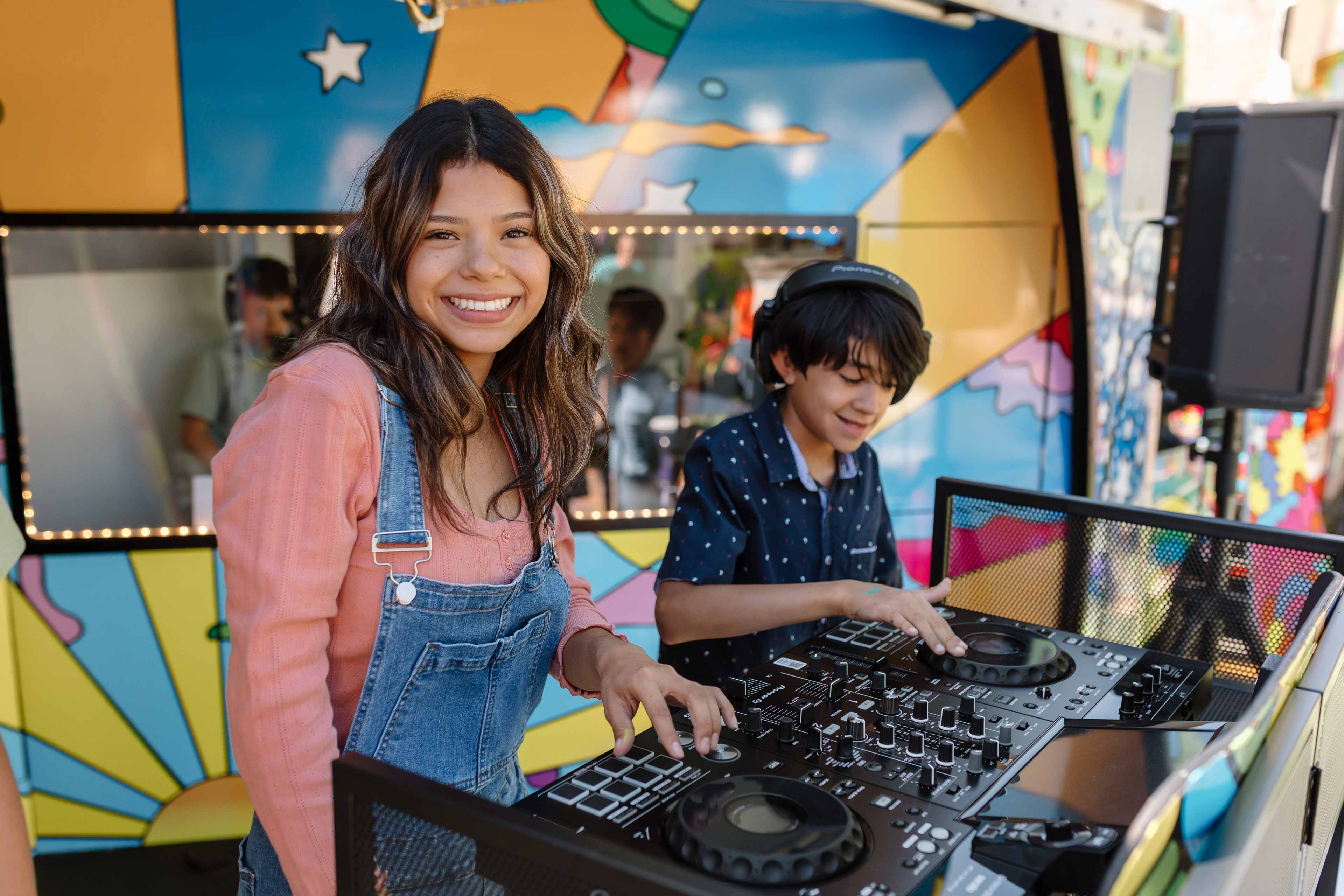 kids playing music with a dj controller on a family party