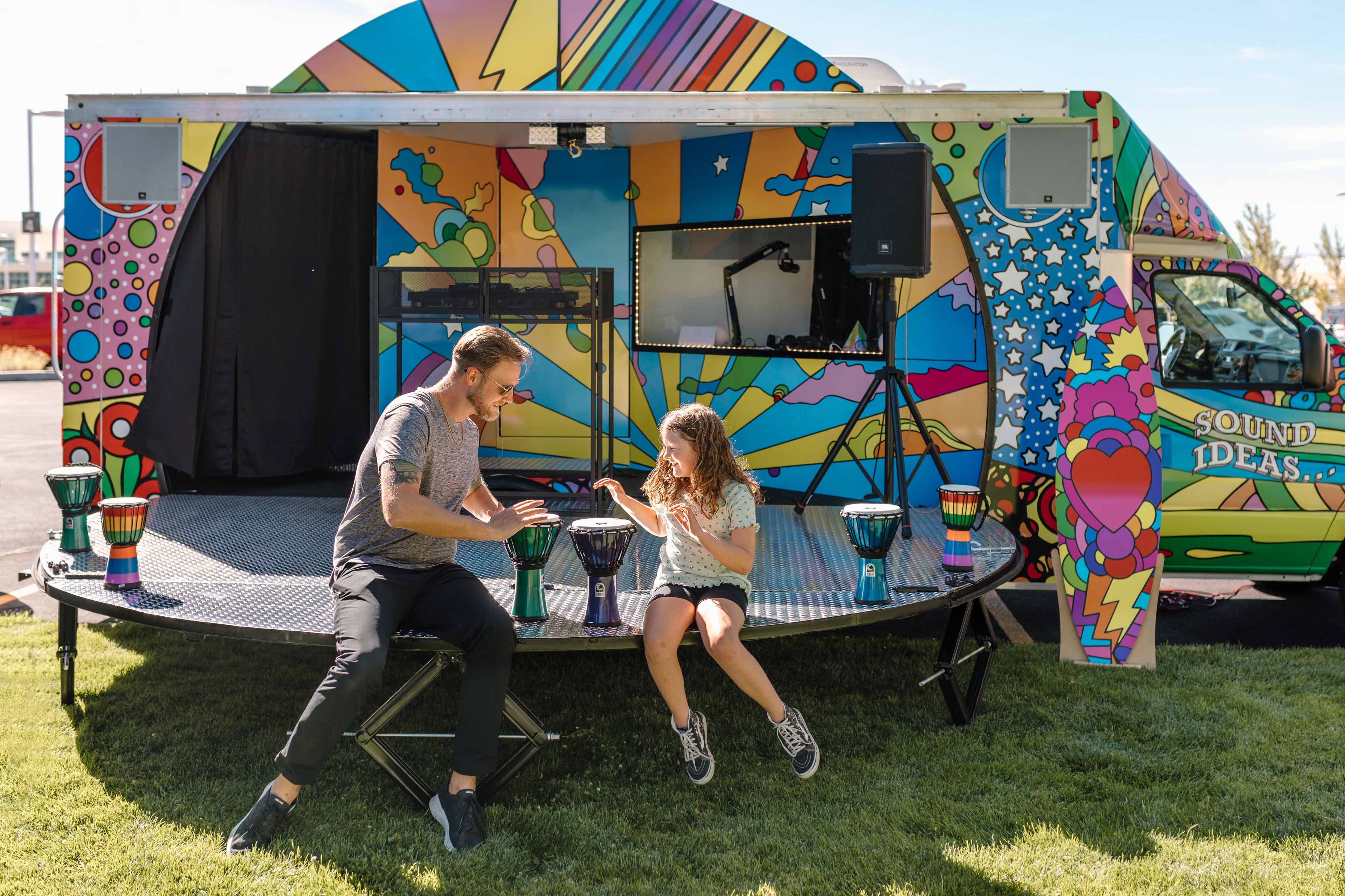 father and daughter playing with a drums instrument